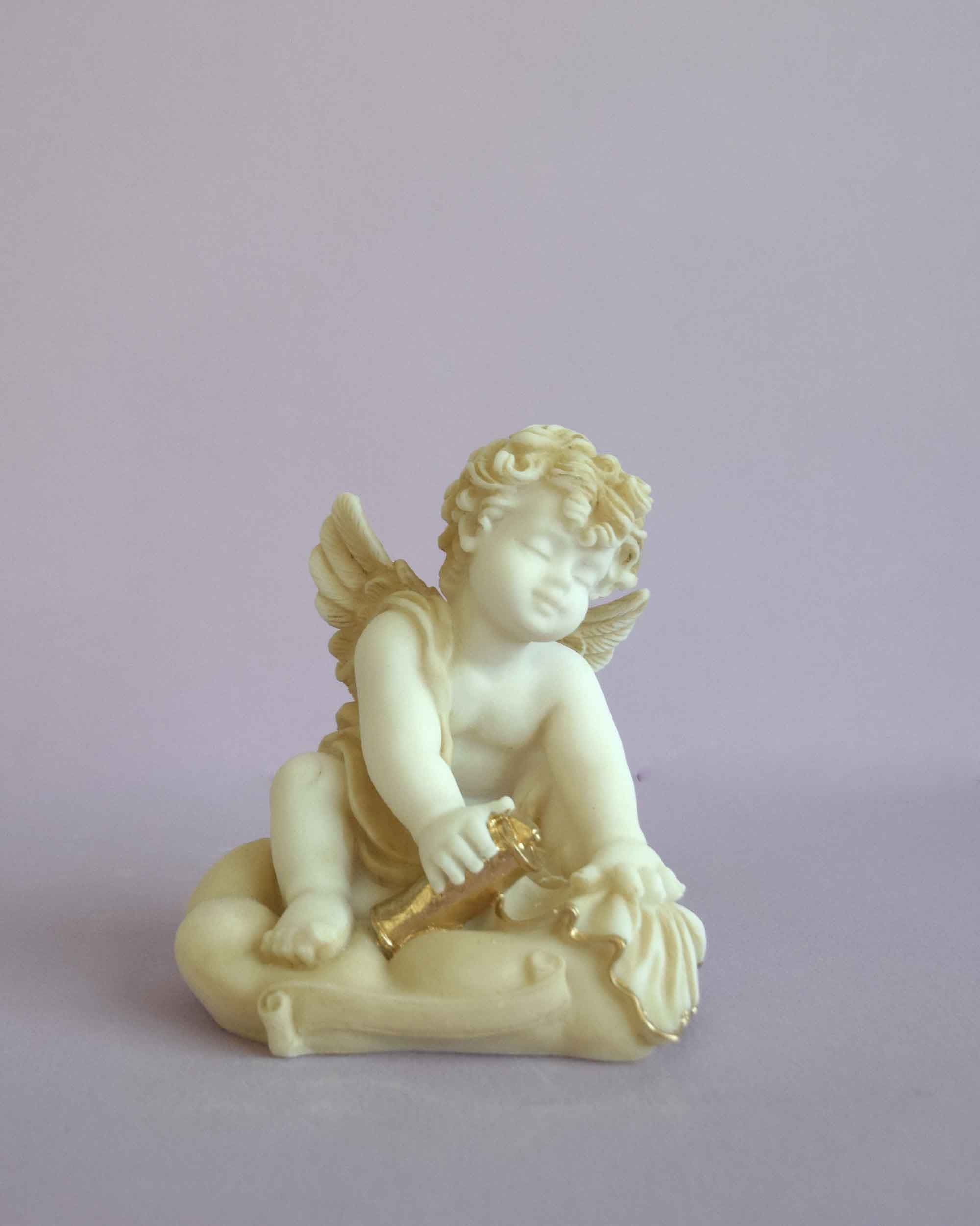 Angel holding papyrus statue