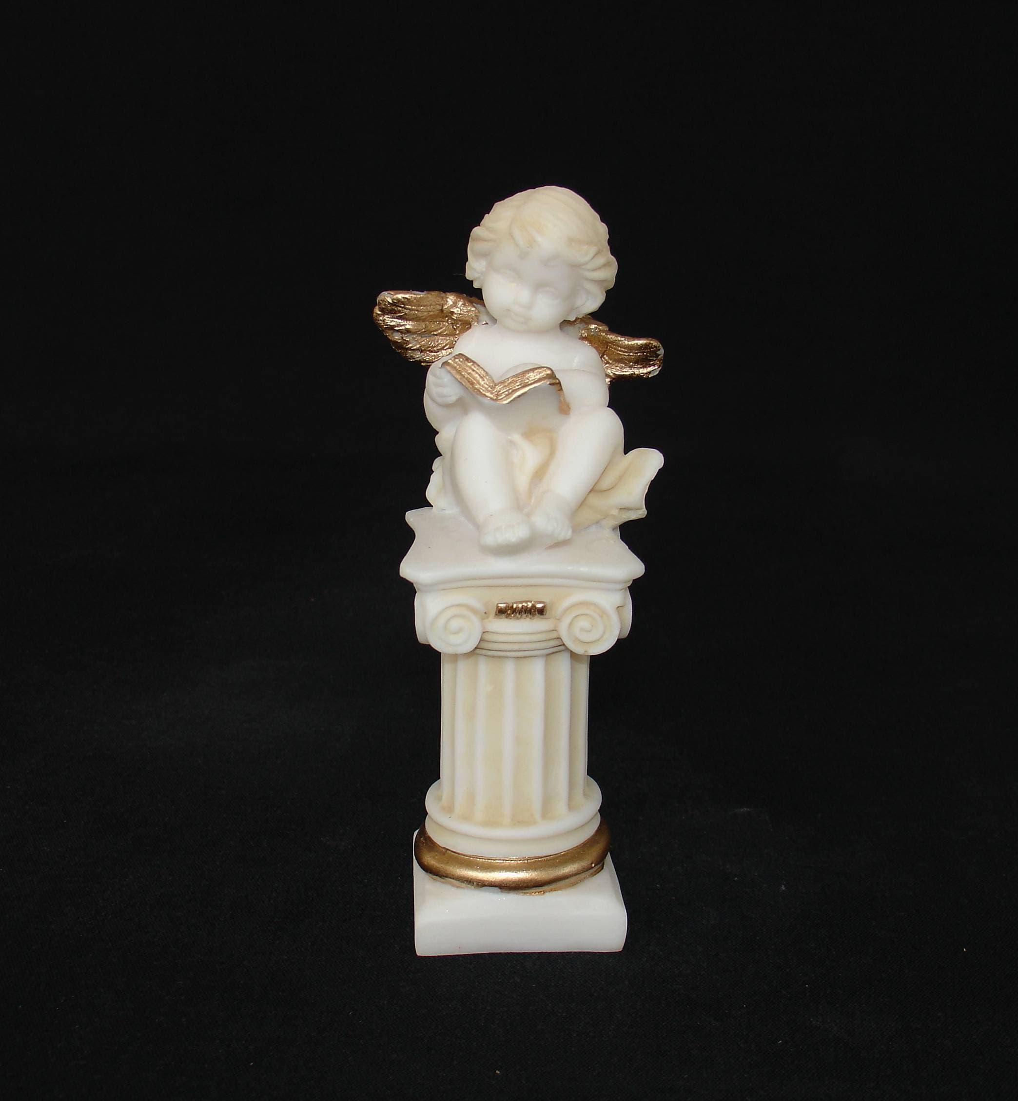 Angel sitting on a column statue