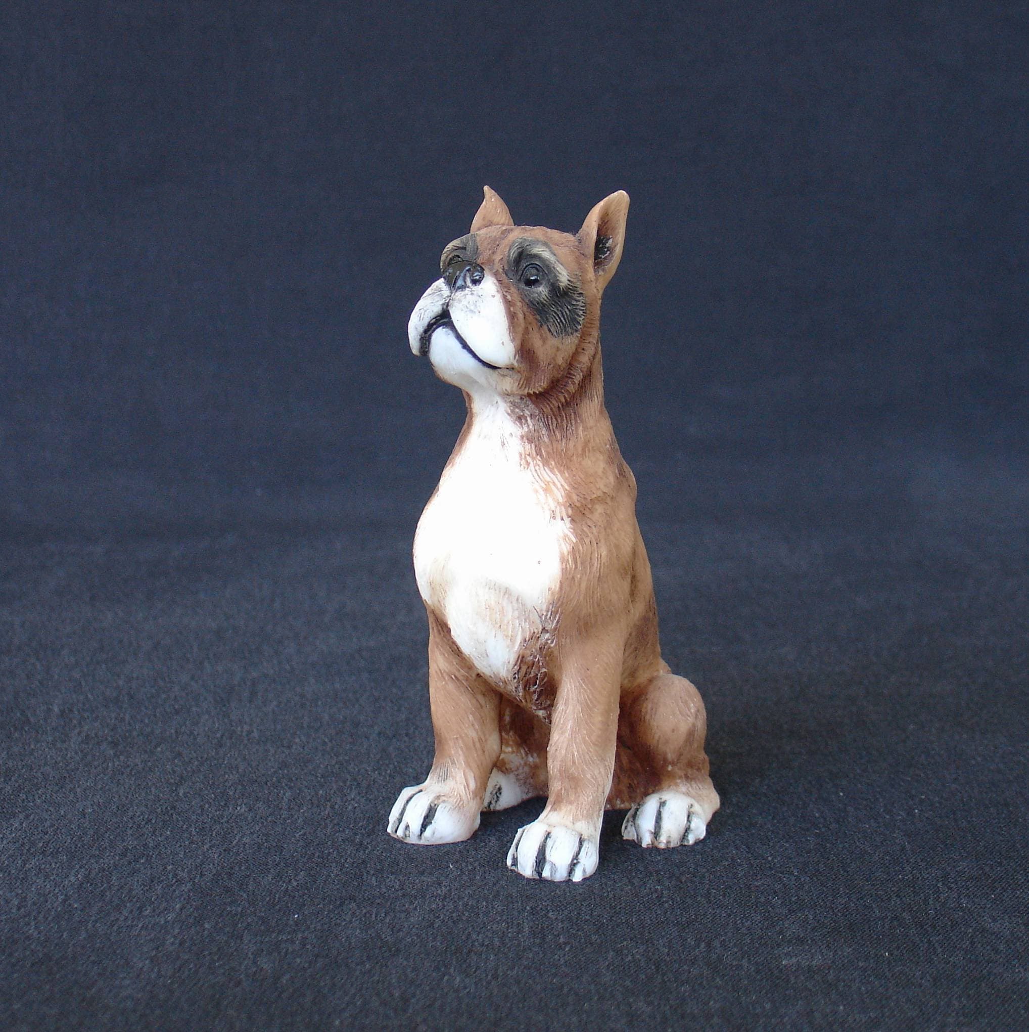 Boxer pet dog statue sitting on the floor