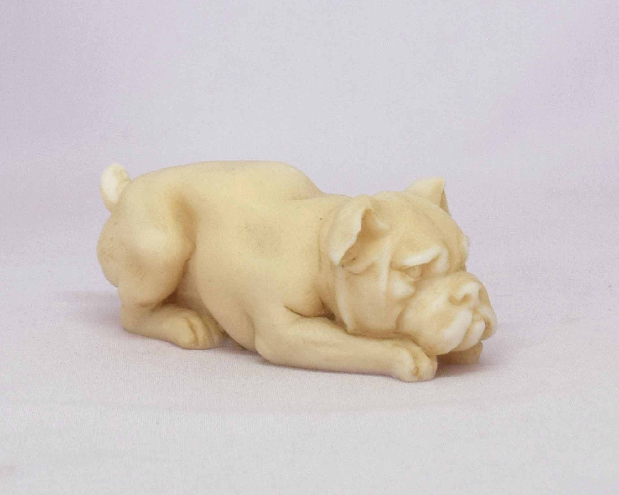 Dog sitting down on the floor statue