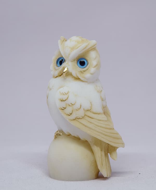 Owl sitting on a sphere statue