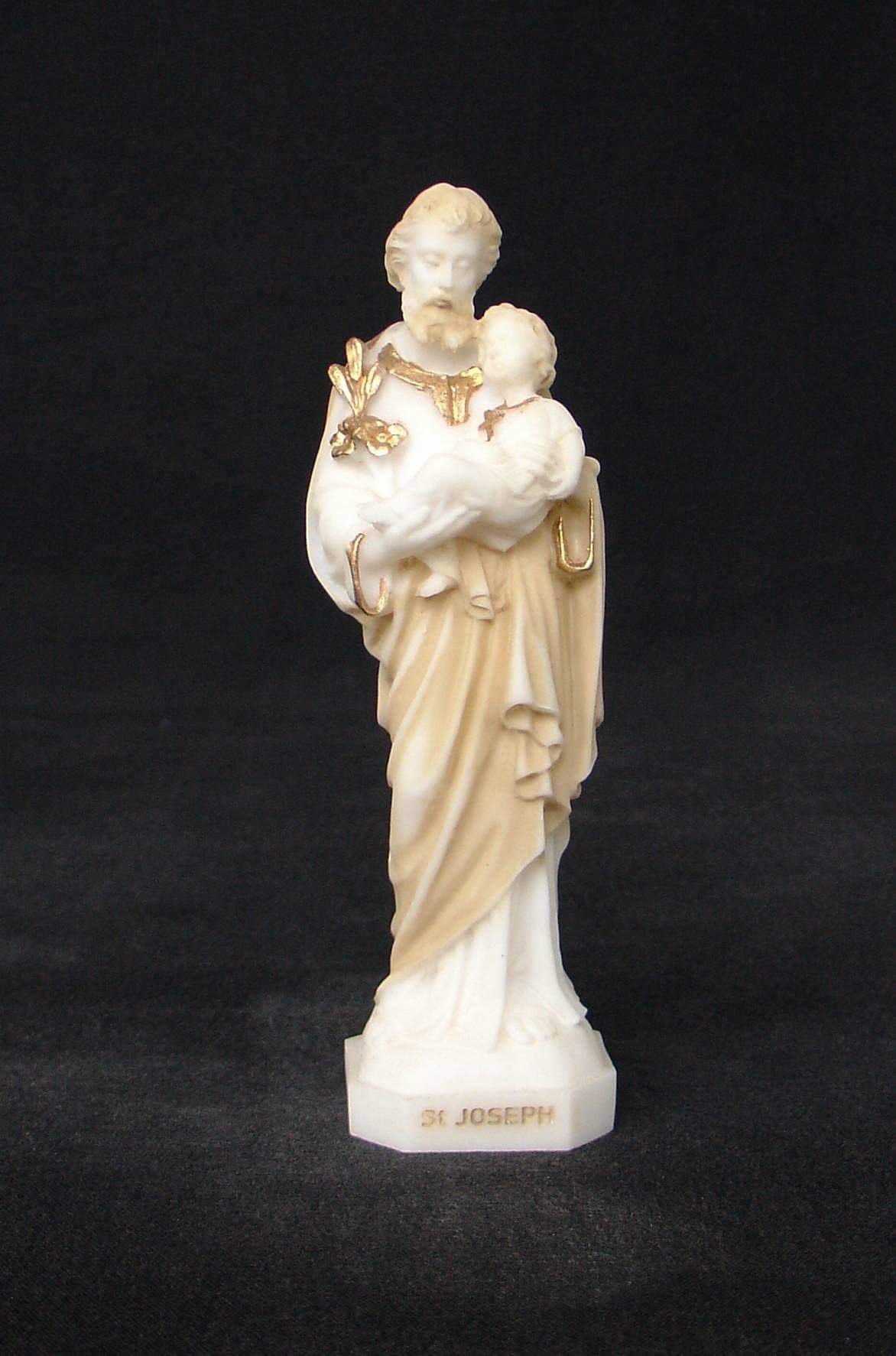 Saint Joseph holding baby Jesus in his both hands