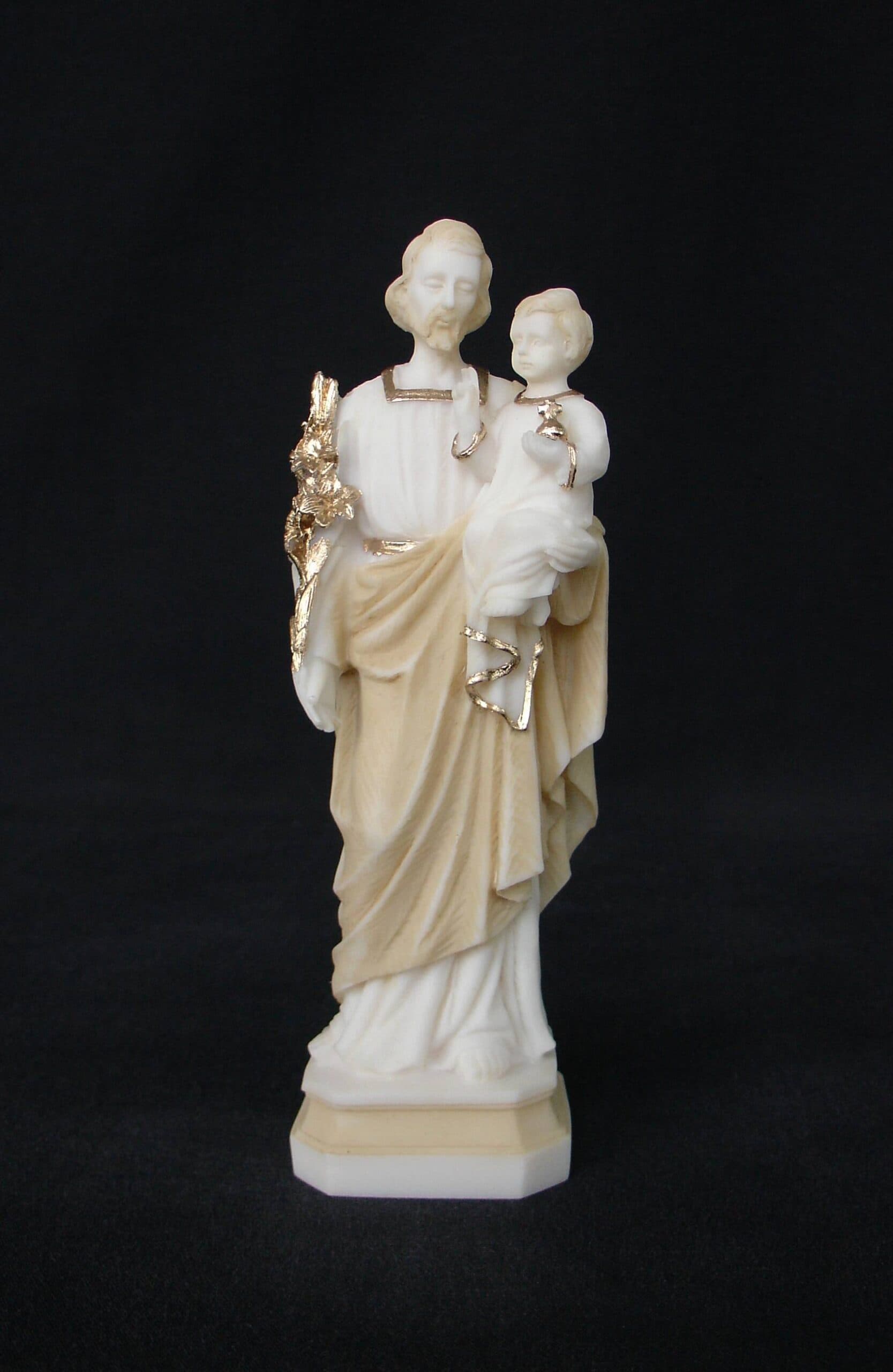 Saint Joseph holding baby Jesus in his hand